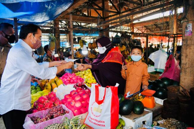 Presiden Joko Widodo membagikan bantuan langsung tunai bagi para pedagang kaki lima dan warung di Pasar Induk Sidikalang, Kabupaten Dairi, Provinsi Sumatera Utara. Foto: BPMI Setpres/Laily Rachev